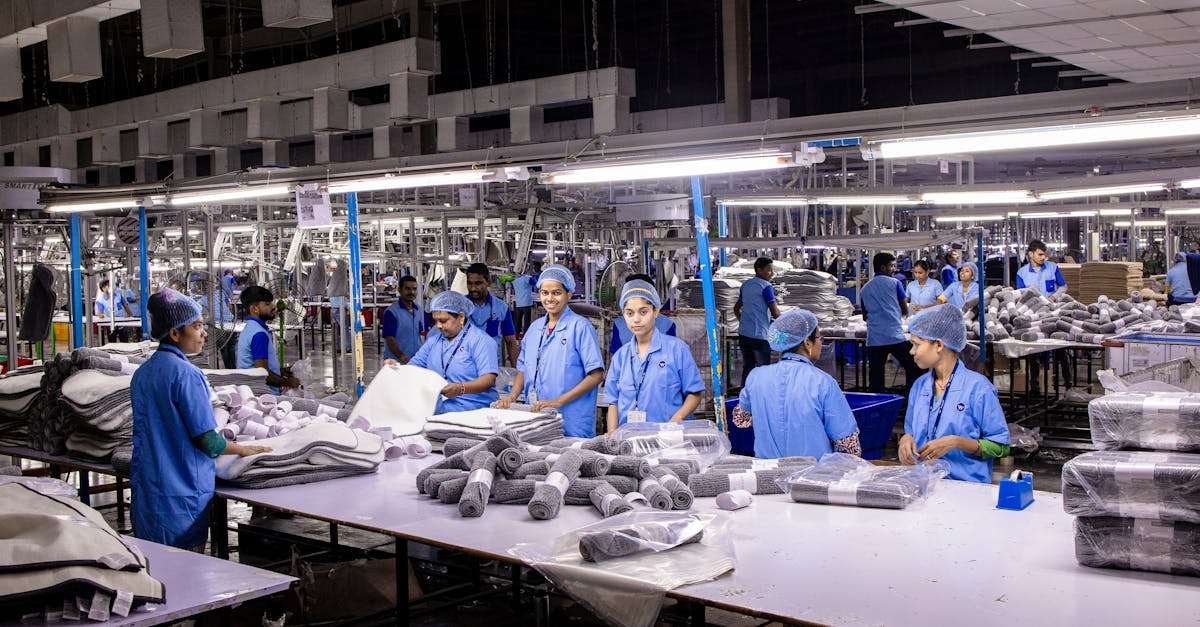 Indian textile factory workers expertly packaging products on an assembly line.
